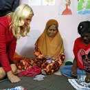 Crown Princess Mette-Marit listens to caregivers making floor mats as she visits a shelter for children with HIV/AIDS in Kuala Lumpur on May 29, 2013 (Photo: Bazuki Muhammad, AFP)